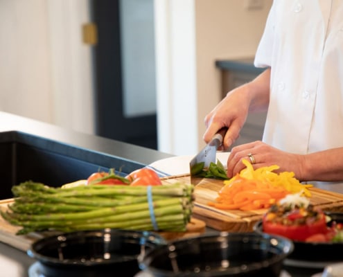Personal chef chopping vegetables.