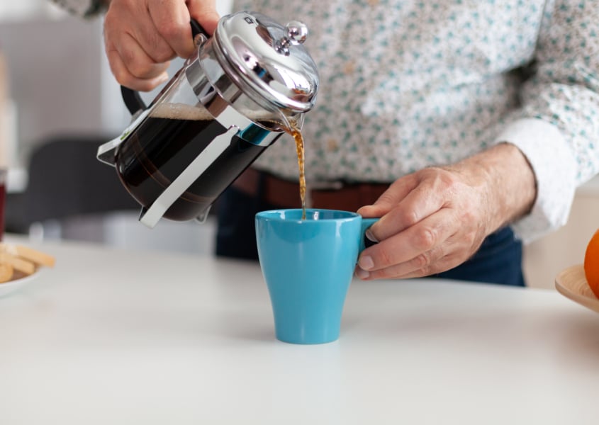Senior man pouring coffee