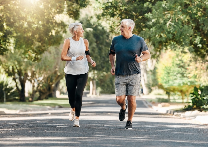 Senior couple walking together in a park.