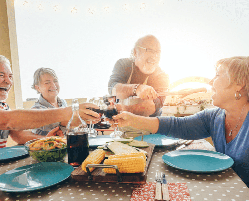 two senior couples cheers over healthy food