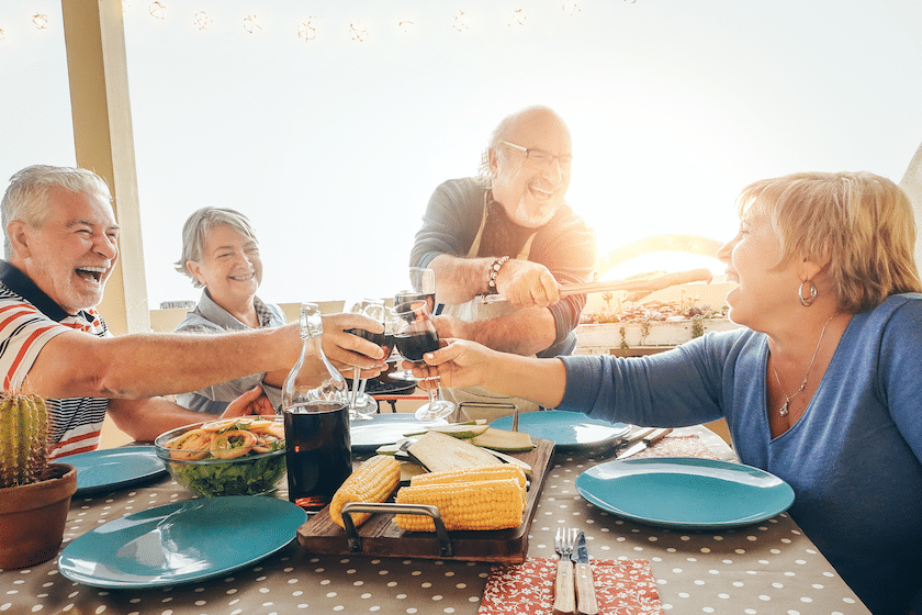 two senior couples cheers over healthy food
