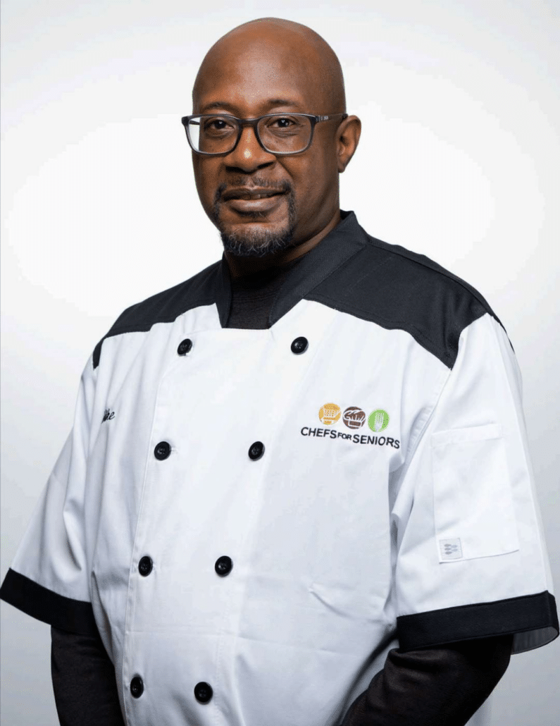 Headshot of Chefs For Seniors Metro Detroit & Ann Arbor, Michigan owner and personal chef, Michael Jackson in a Chefs For Seniors branded chef coat